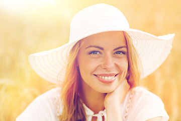 Image showing close up of happy woman in sun hat on cereal field