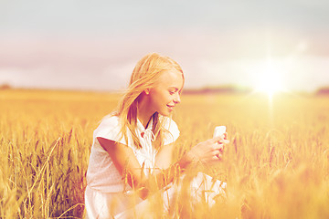 Image showing happy woman with smartphone and earphones