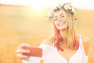 Image showing happy young woman taking selfie by smartphone