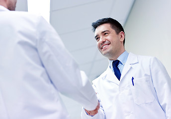 Image showing smiling doctors at hospital doing handshake