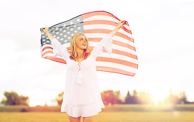 Image showing happy woman with american flag on cereal field