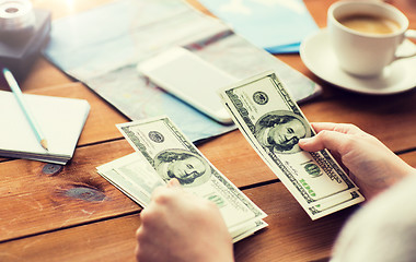 Image showing close up of traveler hands counting dollar money