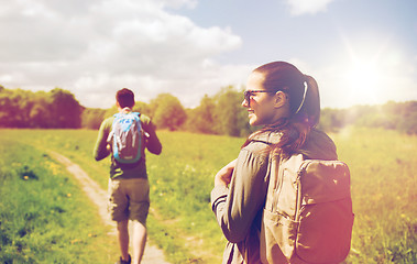 Image showing happy couple with backpacks hiking outdoors