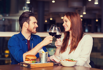 Image showing happy couple dining and drink wine at restaurant