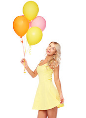 Image showing happy woman in dress with helium air balloons