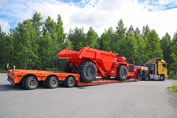 Image showing Silvasti Truck Hauls Sandvik Mining Vehicle Rear View