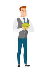 Image showing Happy caucasian businessman holding money.