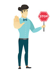 Image showing Asian businessman holding stop road sign.