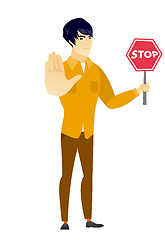 Image showing Asian businessman holding stop road sign.