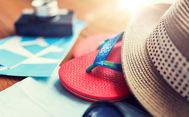 Image showing close up of travel tickets, flip-flops and hat