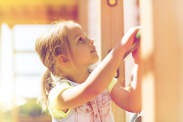 Image showing happy little girl climbing on children playground