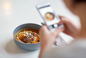 Image showing woman with smartphone photographing food at cafe