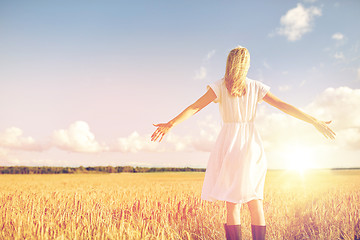 Image showing happy young woman in white dress on cereal field