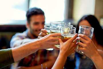 Image showing happy friends drinking beer at bar or pub