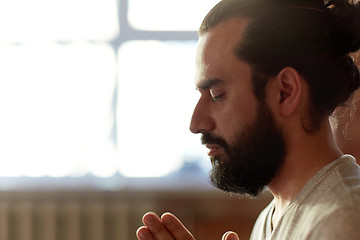 Image showing close up of man meditating at yoga studio