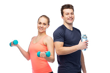 Image showing sportive man and woman with dumbbell and water