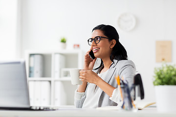 Image showing businesswoman calling on smartphone at office