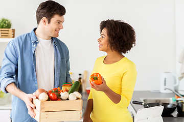 Image showing happy couple with healthy food at home kitchen