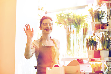 Image showing smiling florist woman at flower shop cashbox