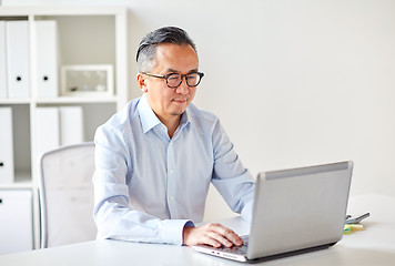 Image showing businessman in eyeglasses with laptop office