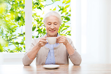 Image showing happy senior woman with cup of coffee