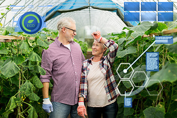 Image showing happy senior couple at farm greenhouse