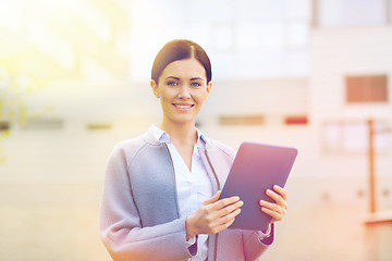 Image showing smiling business woman with tablet pc in city