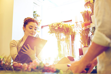 Image showing florist woman and man making order at flower shop