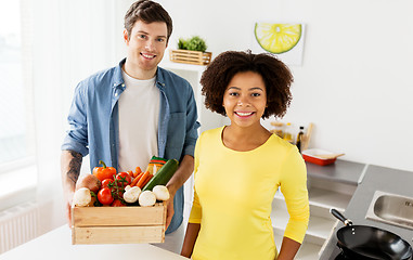 Image showing happy couple with healthy food at home kitchen