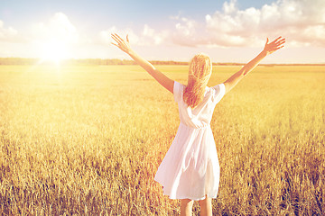 Image showing happy young woman in white dress on cereal field