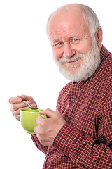 Image showing Cheerfull senior man with green cup, isolated on white