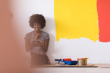 Image showing back female painter sitting on floor