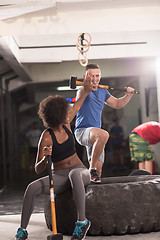 Image showing multiethnic couple after workout with hammer