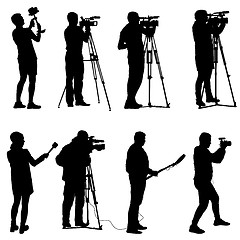 Image showing Set cameraman with video camera. Silhouettes on white background