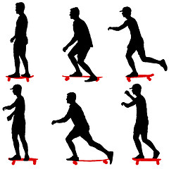 Image showing Set ilhouettes a skateboarder performs jumpingon a white background