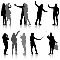 Image showing Set silhouettes man and woman taking selfie with smartphone on white background. illustration