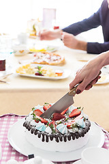 Image showing The waitress is cutting the strawberry