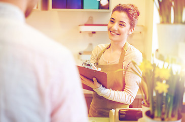 Image showing florist woman and man making order at flower shop