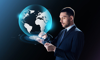 Image showing businessman with tablet pc and earth projection