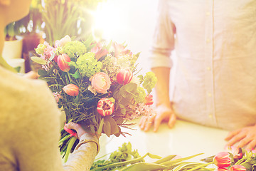 Image showing close up of florist woman and man at flower shop
