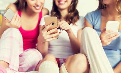 Image showing friends or teen girls with smartphones at home