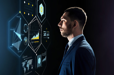 Image showing businessman in suit looking at virtual projection