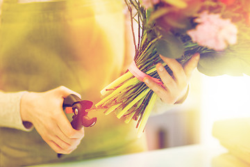 Image showing close up of florist woman with flowers and pruner