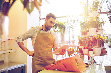 Image showing man with tablet pc computer at flower shop