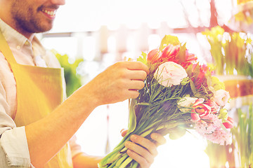 Image showing close up of florist man with bunch at flower shop