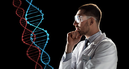 Image showing scientist in goggles looking at dna molecule