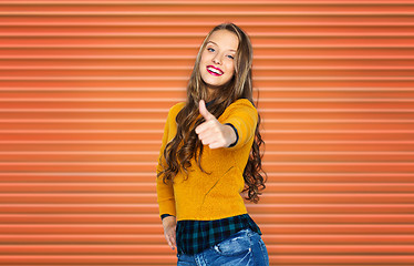 Image showing happy young woman or teen girl showing thumbs up