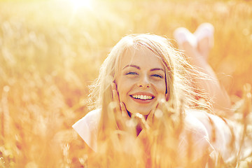 Image showing happy woman or teen girl lying in cereal field