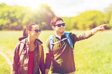 Image showing happy couple with backpacks hiking outdoors