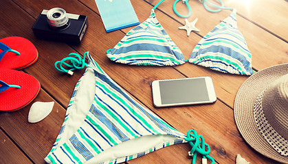 Image showing close up of smartphone and beach stuff